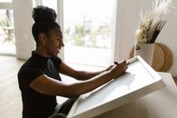 Woman in Black Shirt Sitting on Window