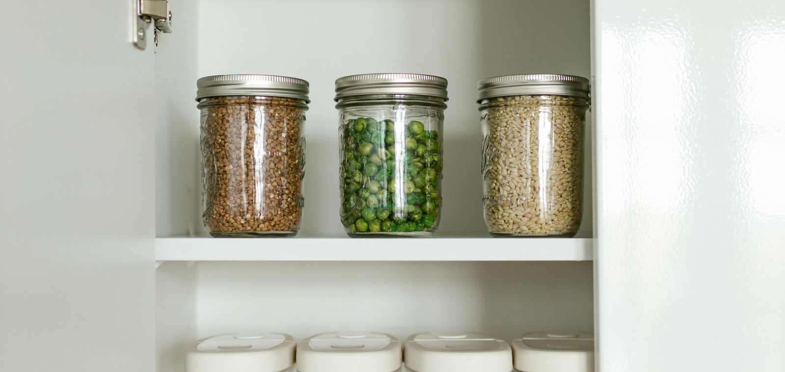 Kitchen cabinet with food in jars and boxes