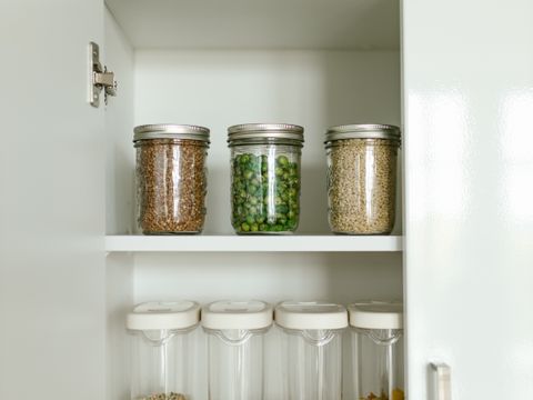 Kitchen cabinet with food in jars and boxes