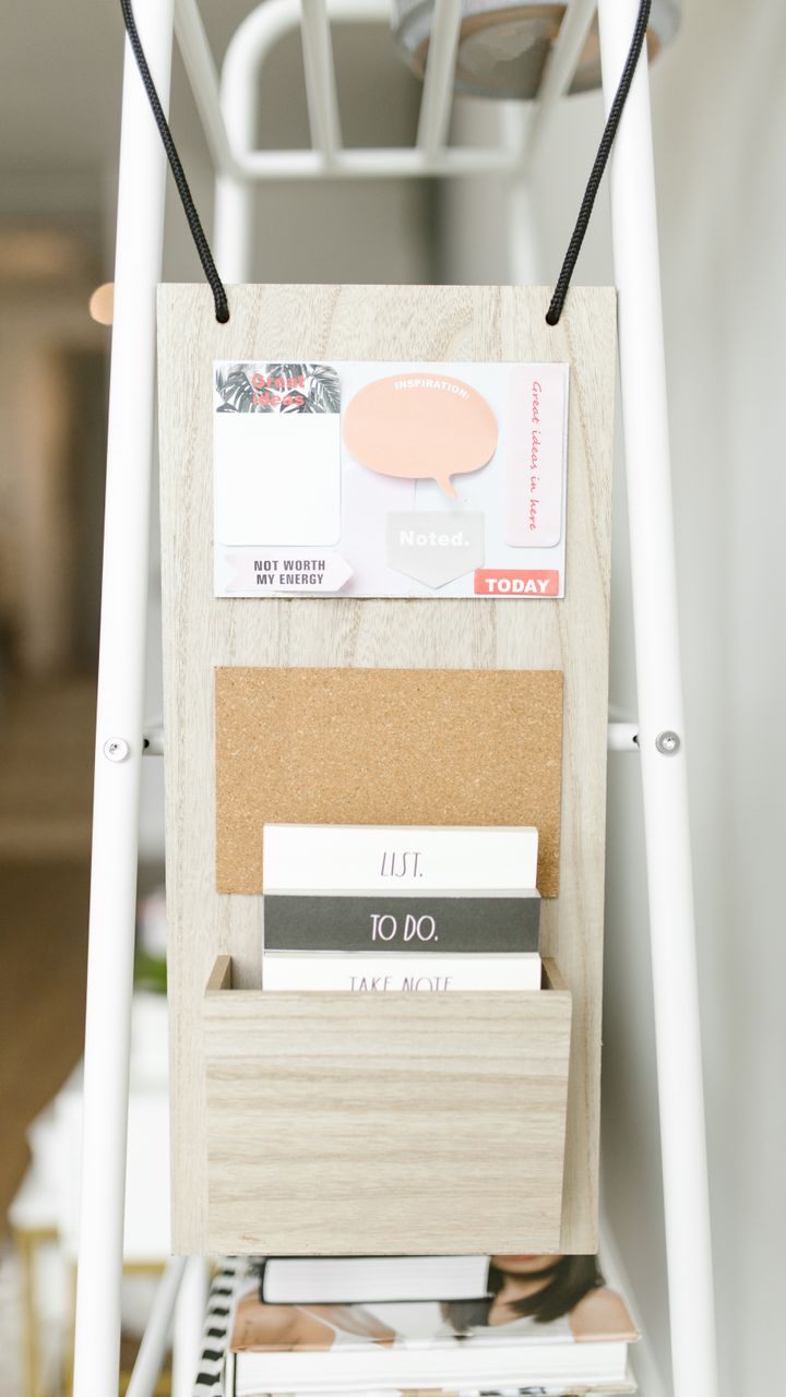 Wall-mounted corkboard organizer holding coffee supplies for a dollar tree coffee bar design