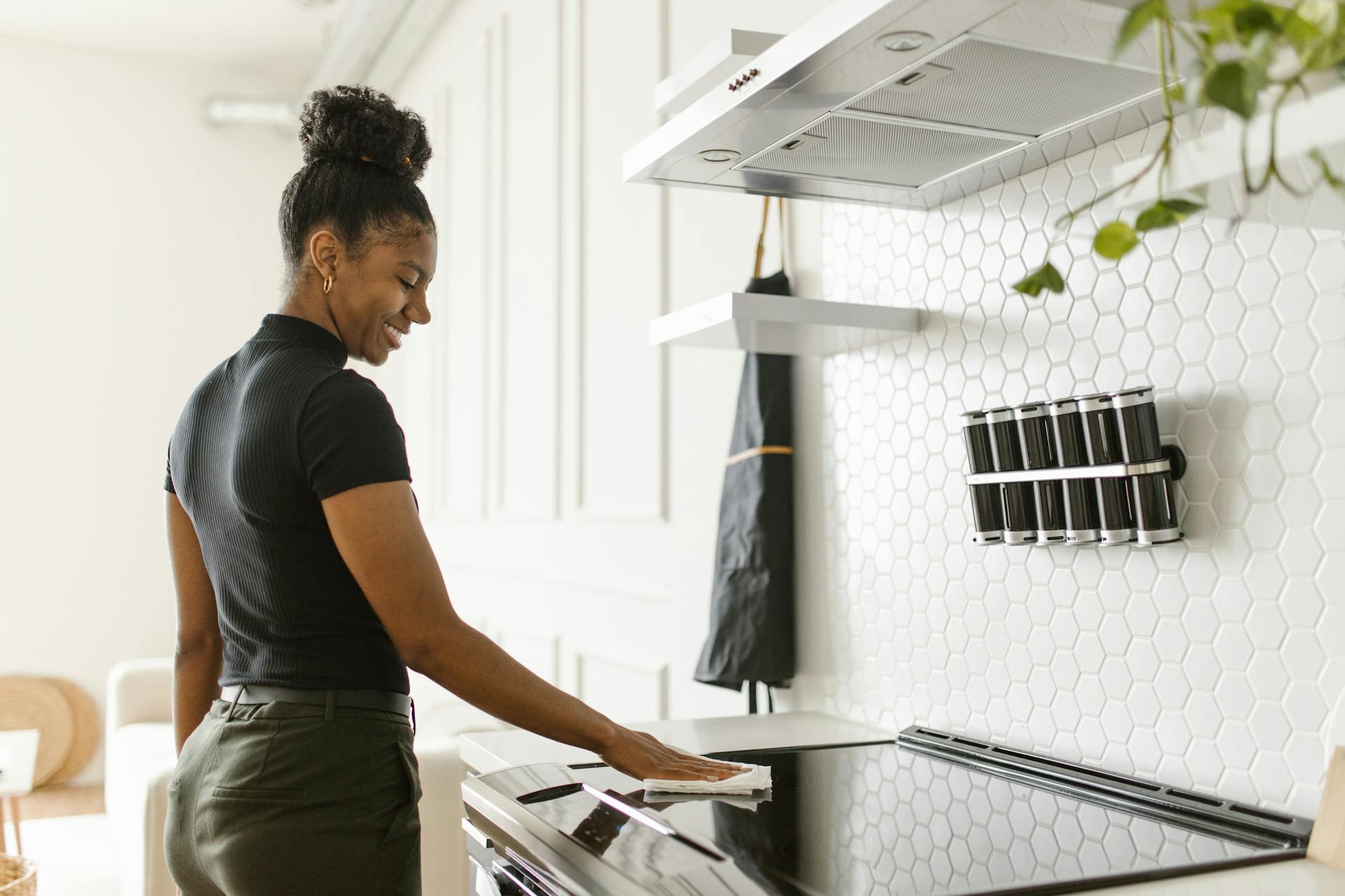 Responsible Woman wiping an Electric Stove Clean