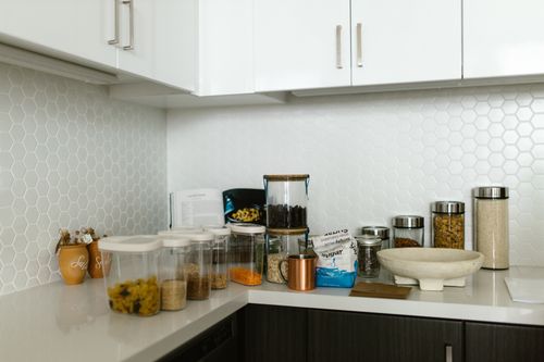 Free A neatly organized kitchen counter with various food storage containers. Stock Photo