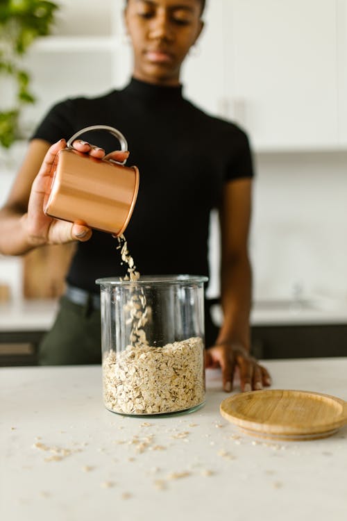 Pouring of Oats in a Glass Jar