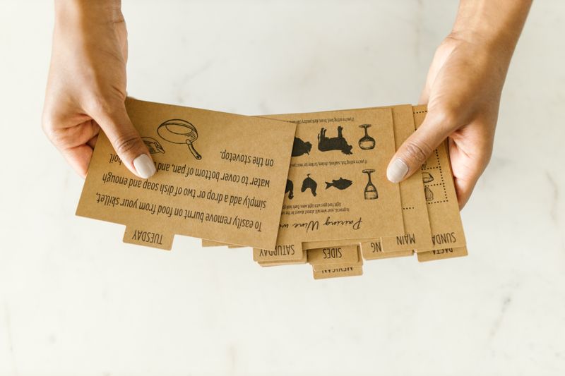 corkboard with printed recipe cards pinned up