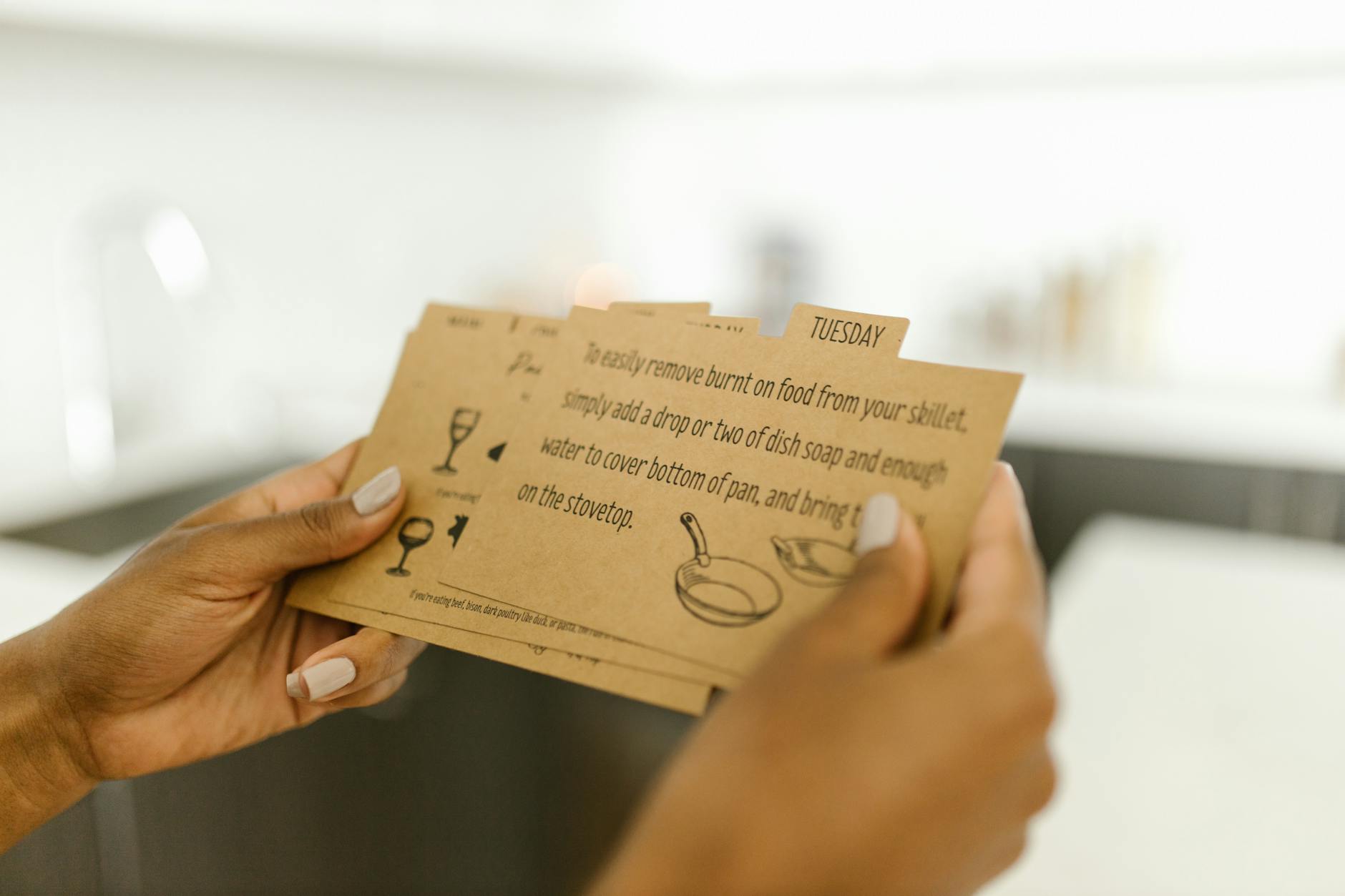Woman holding instructional cards with text and illustrations
