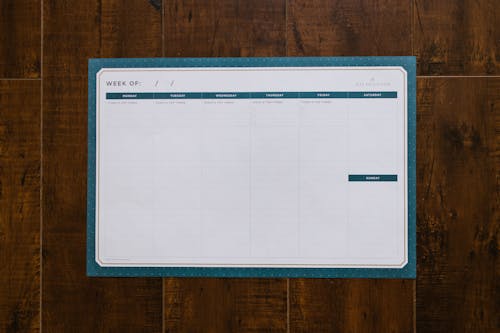 A Weekly Organizer on a Wooden Surface