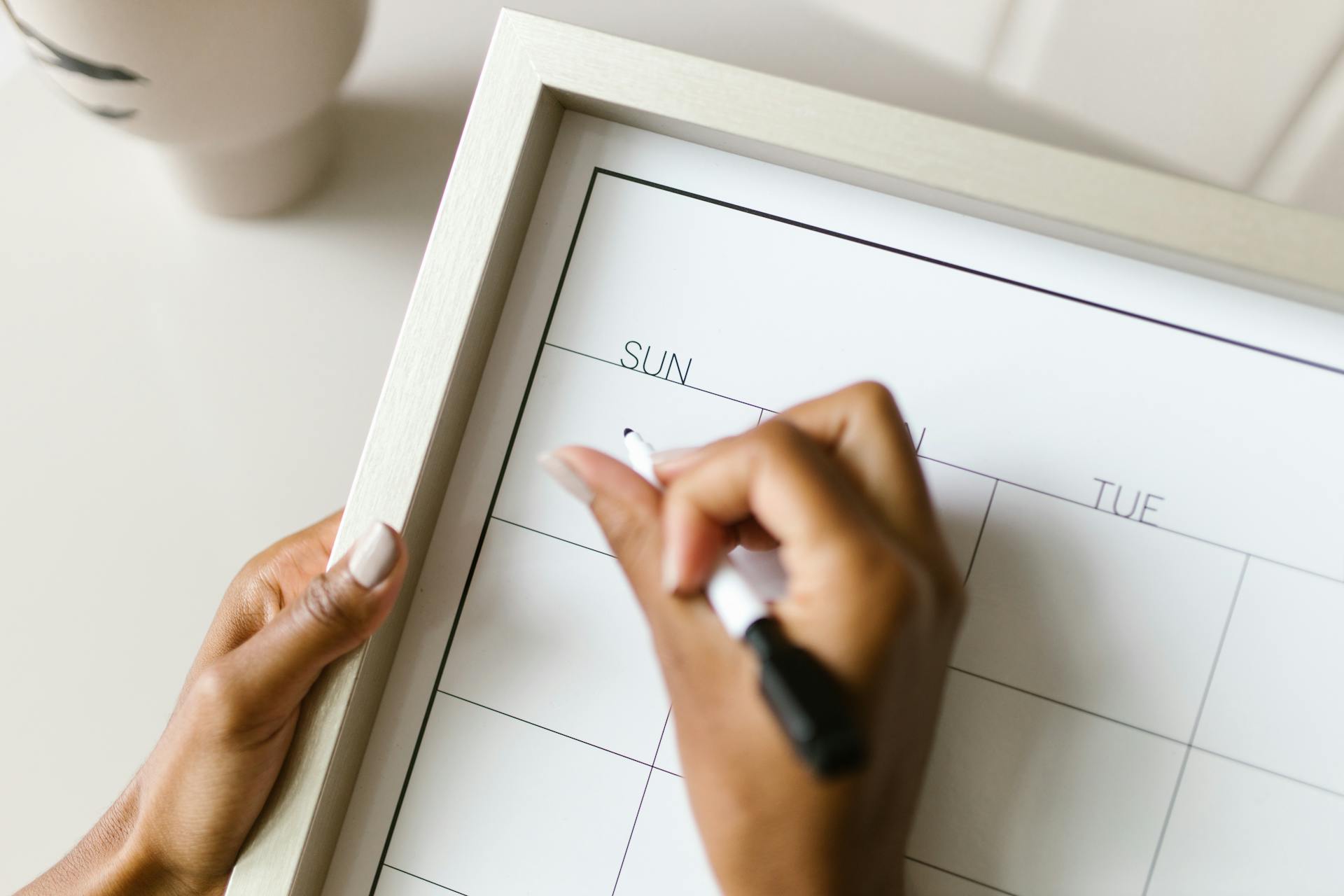 Woman Writing in Calendar