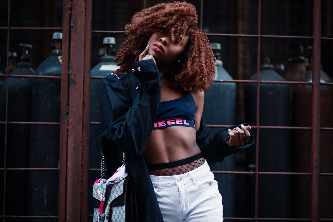 Woman wearing white Nike sports bra and brown and black plaid jacket photo  – Free Style Image on Unsplash