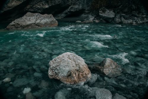 Free Serene mountain stream flowing over rocks in North Ossetia's picturesque landscape. Stock Photo