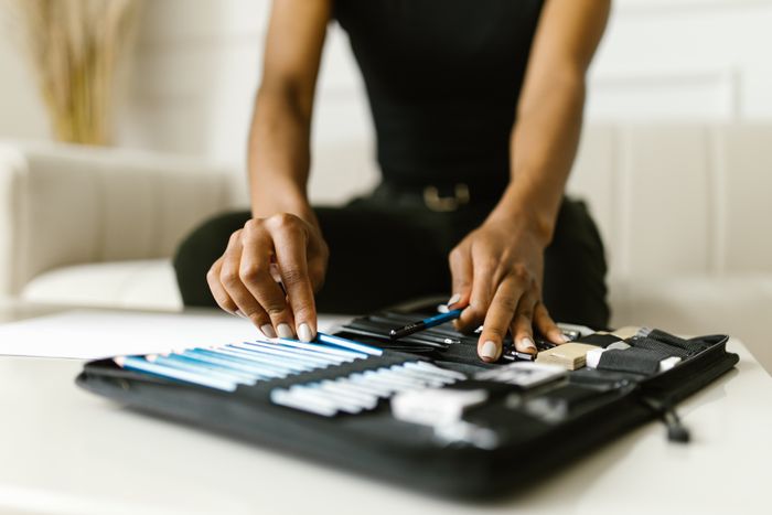 Hands opening a zipped stationery pouch — photo by RDNE Stock project on Pexels