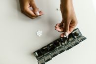 Person Holding White Tablet