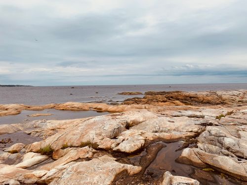 Free Peaceful seascape with dramatic rock formations and overcast sky. Stock Photo
