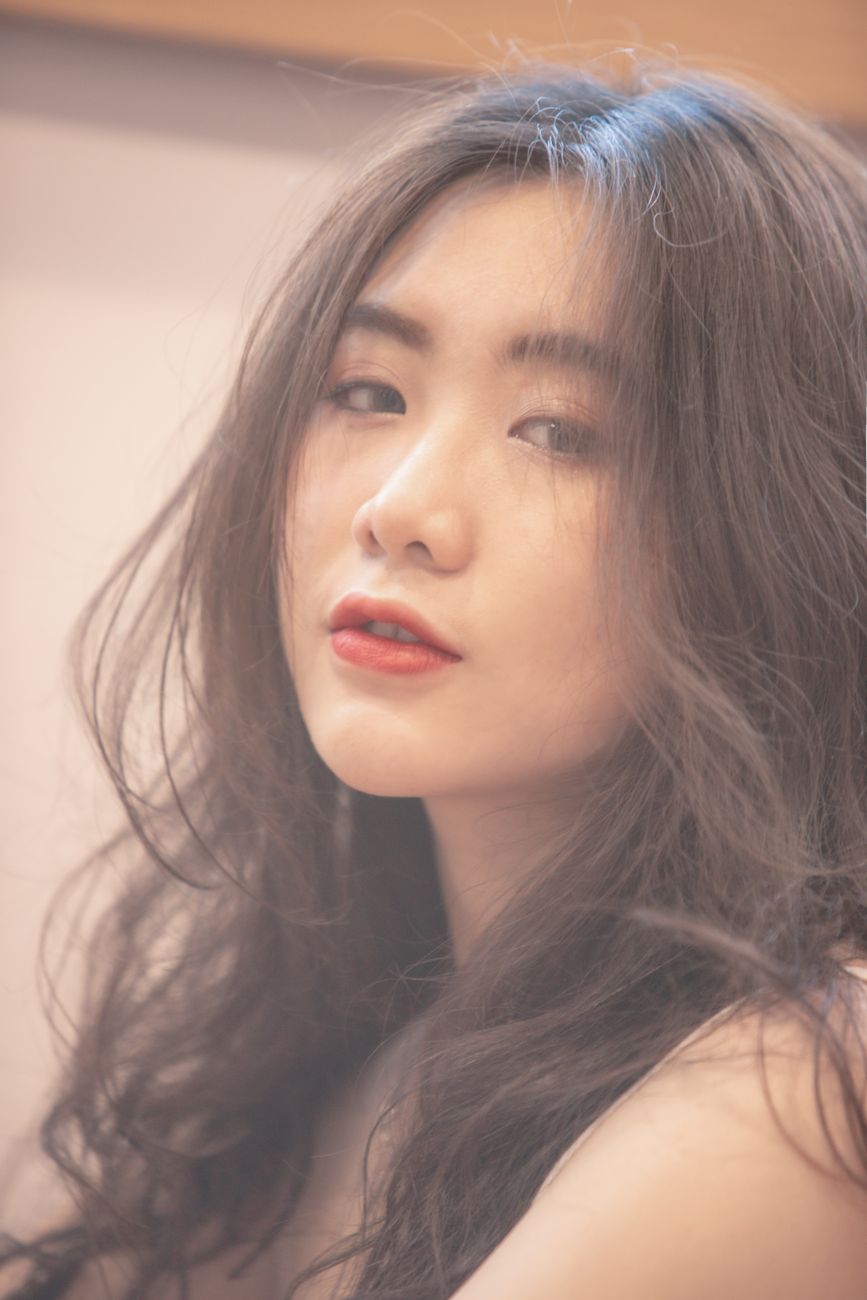 Elegant portrait of a woman with flowing hair and red lips. Perfect for beauty and fashion themes.