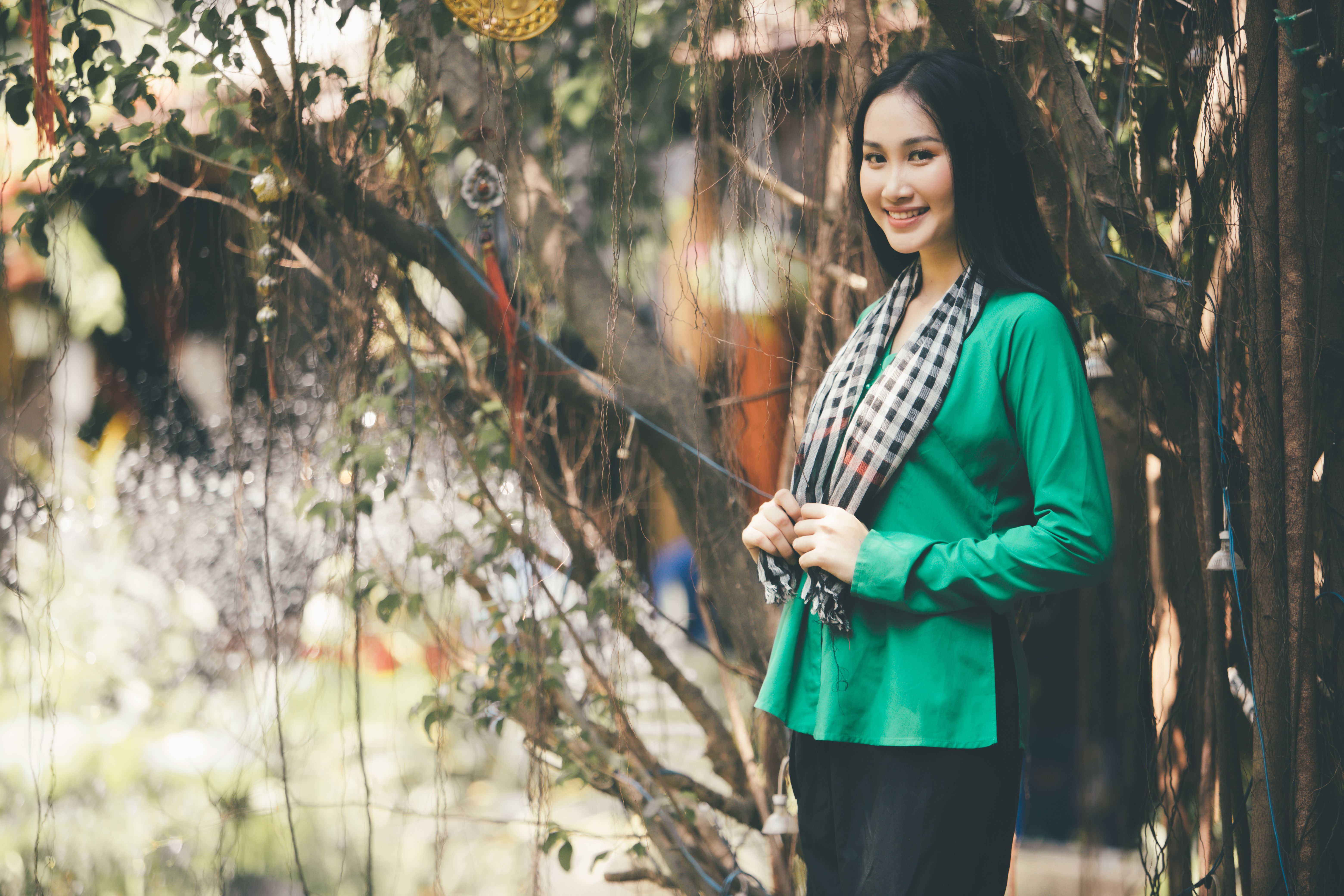 A Beautiful Woman in Green Long Sleeves Near Branches of a Tree · Free ...
