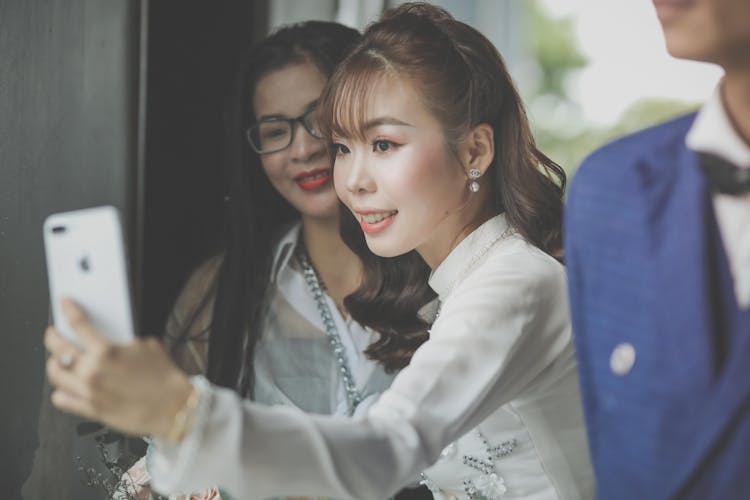 Bride Taking A Selfie With A Wedding Guest 