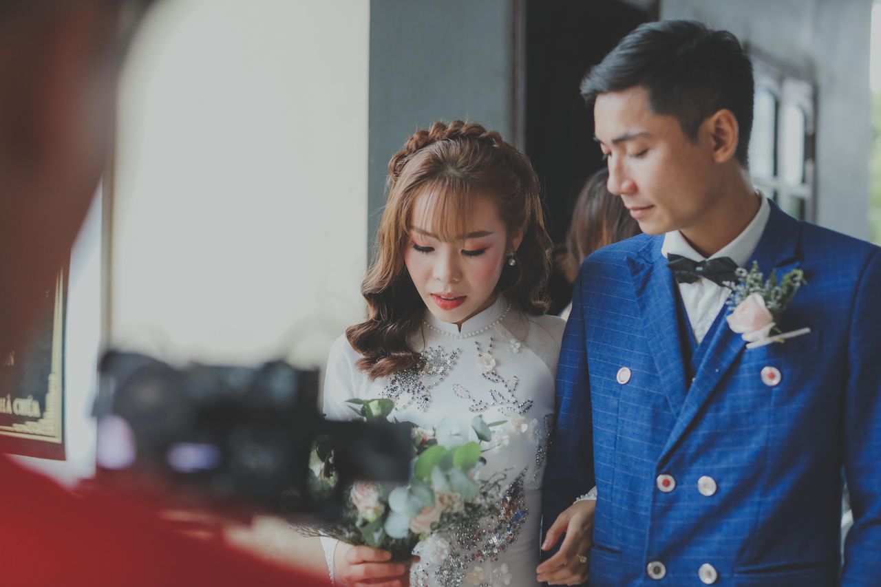 a touching moment shared by an asian couple during their wedding day i