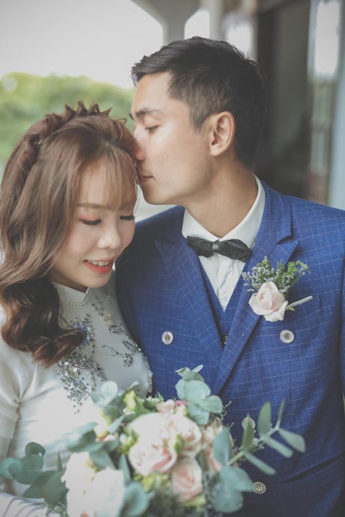 Portrait of Newlyweds with a Bunch of Flowers