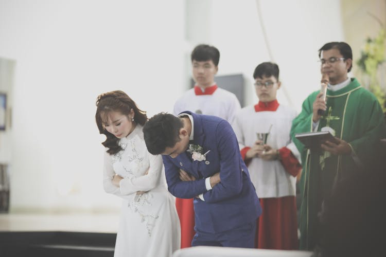 Newlywed Couple Bowing Together