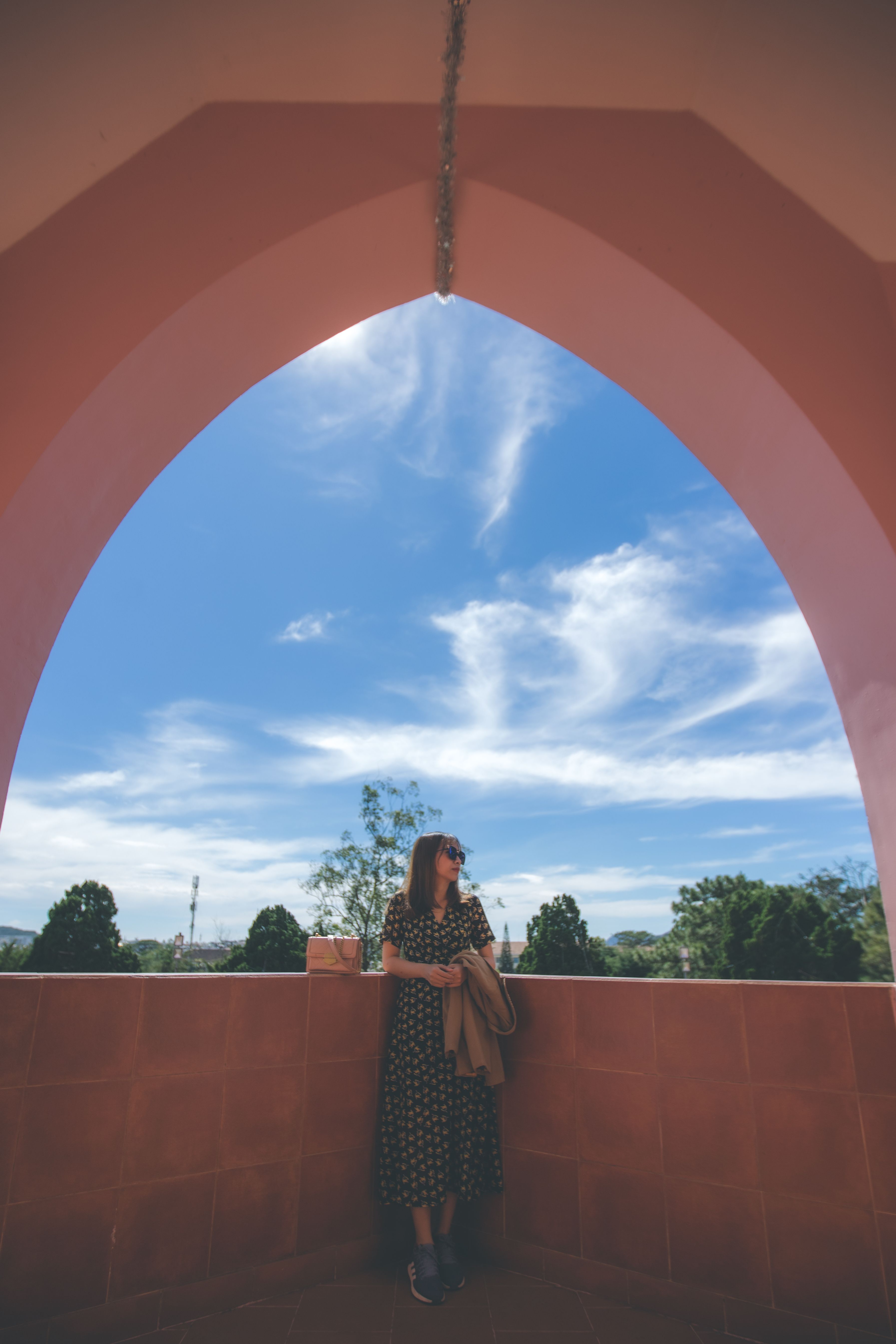 A Woman Standing Beside the Arched Window · Free Stock Photo