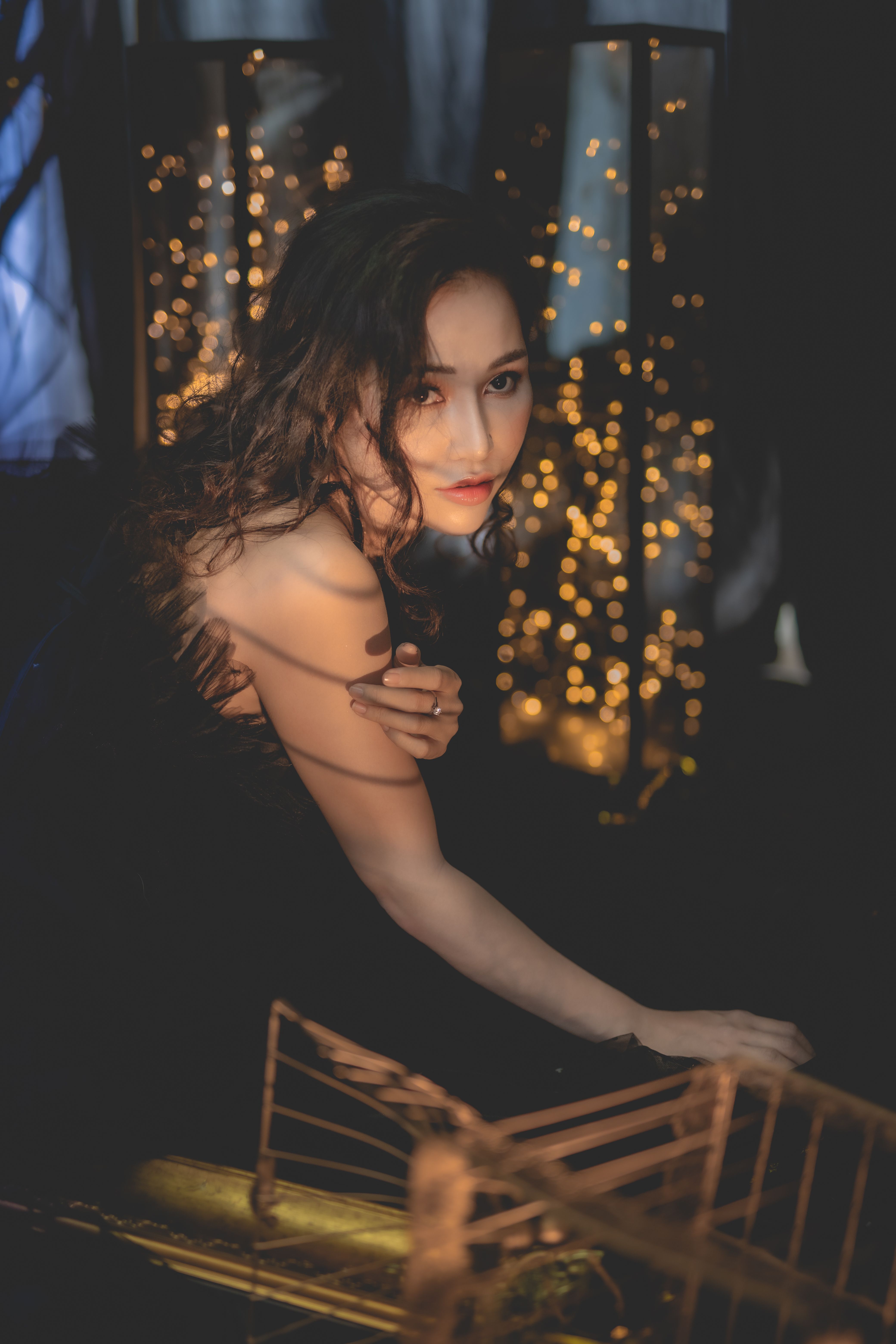 A Woman in Evening Dress Sitting on a Golden Chair · Free Stock Photo