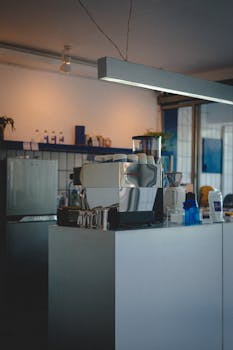 Stylish café interior featuring a sleek espresso machine and contemporary lighting.