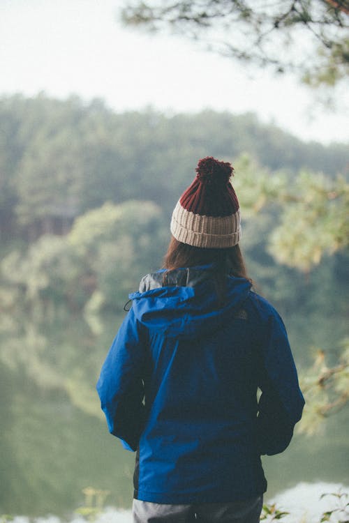 Free Back View of a Person Wearing Beanie and Blue Jacket Stock Photo