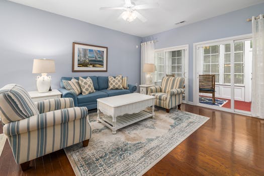 Comfortable living room with sofa, armchairs, and stylish decor for a welcoming ambiance.