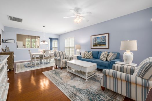 Elegant living room with blue sofas and striped chairs, perfect for home design inspiration.