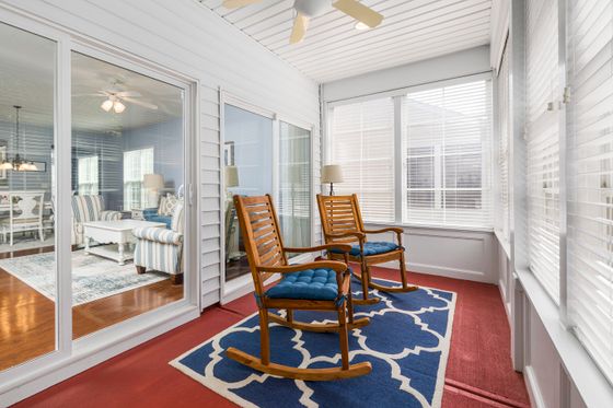 Sunroom with rocking chairs and glass doors to the interior — photo by Curtis Adams on Pexels