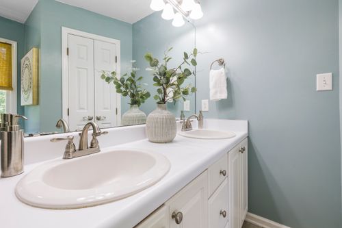 Free Bright contemporary bathroom featuring double sinks and minimalist decor. Stock Photo