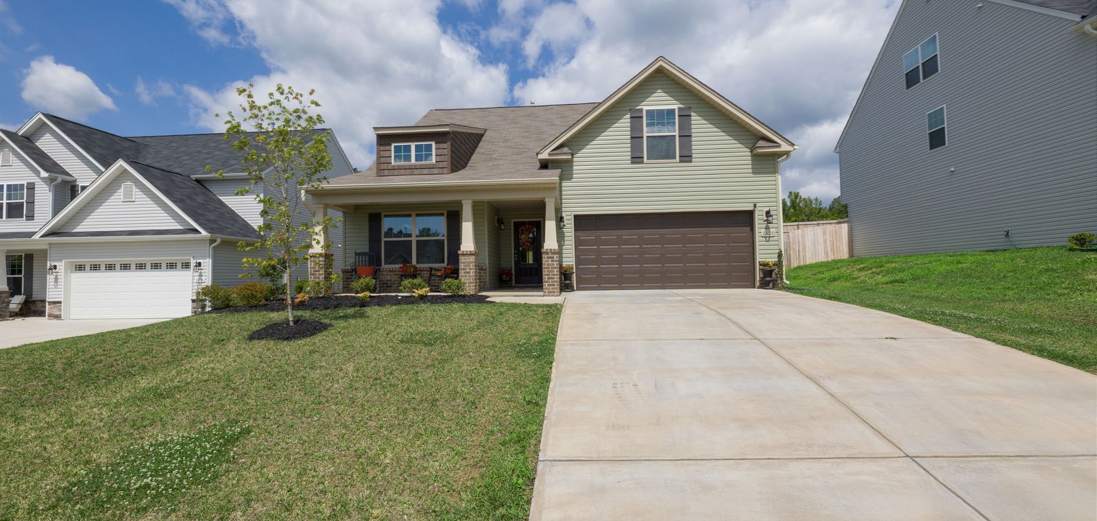 Suburban house with a driveway under a blue sky