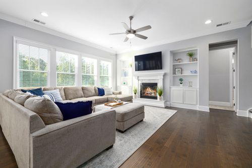 Free Spacious living room featuring neutral tones, cozy sofa, and elegant decor for a modern home feel. Stock Photo