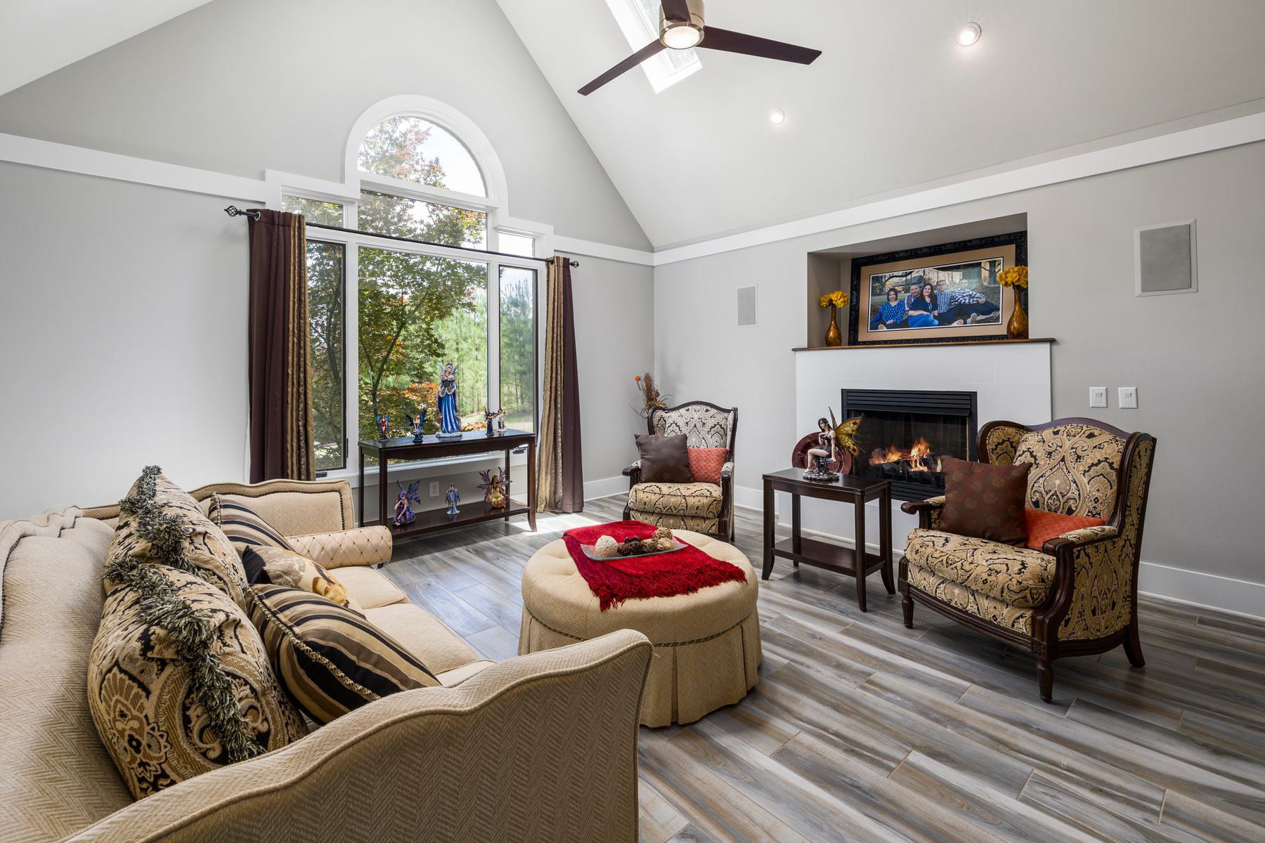 Bright living room with fireplace, sofa and substantial rug