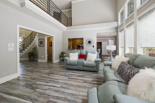 Spacious and stylish living room featuring contemporary decor, natural light, and a cozy ambiance.