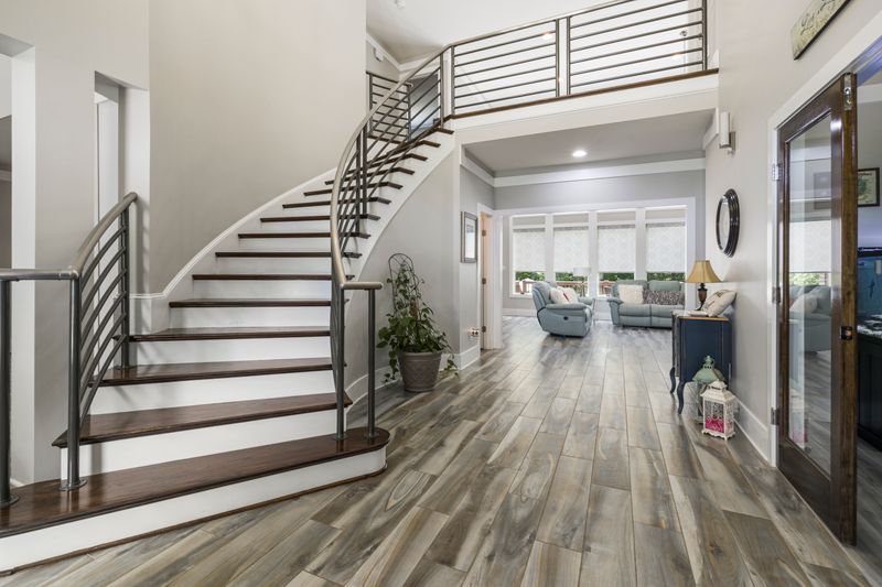 Curved staircase in a bright entrance hall — photo by Curtis Adams on Pexels