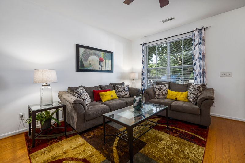 Elegant living room interior featuring a glass coffee table, comfortable sofas, and stylish decor for a cozy ambiance.