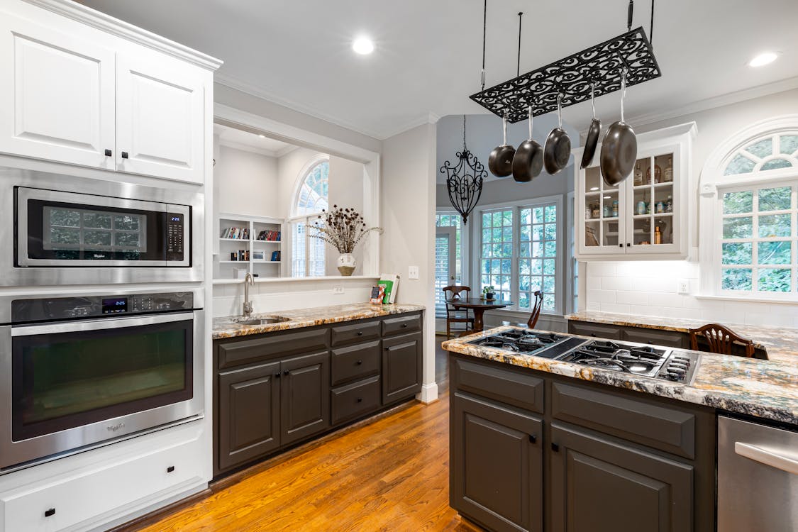 Pots and Pans Hanging Over a Stove on a Kitchen Counter