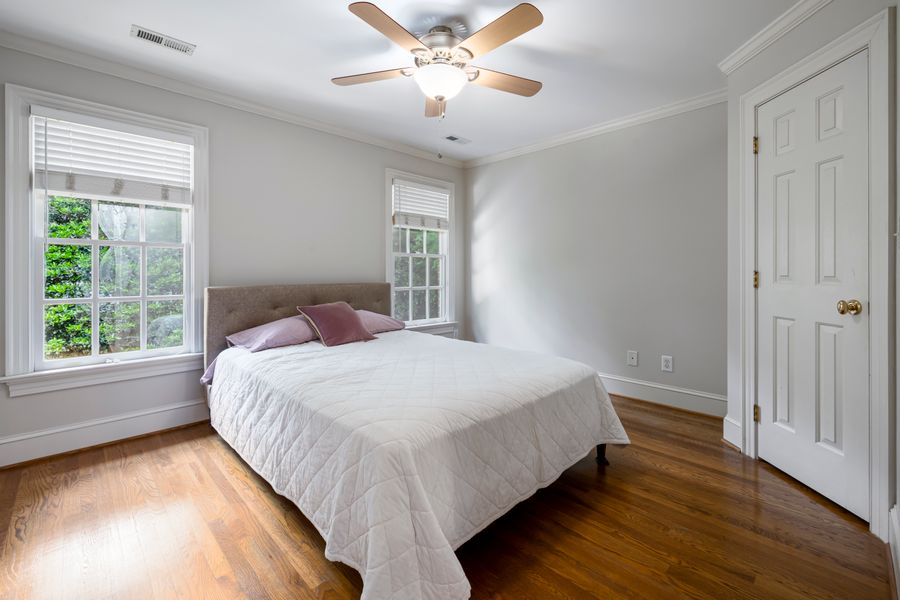 Neatly made bed with crisp white linen in a clean bedroom