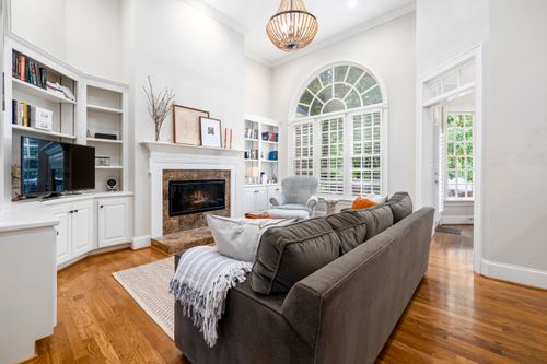 Free Spacious living room featuring modern decor, fireplace, and large window. Stock Photo