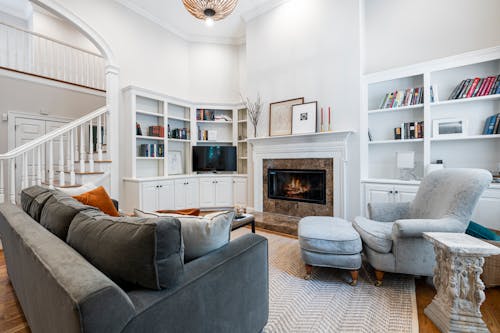 Free A Living Room with a Gray Couch and a Fireplace Stock Photo
