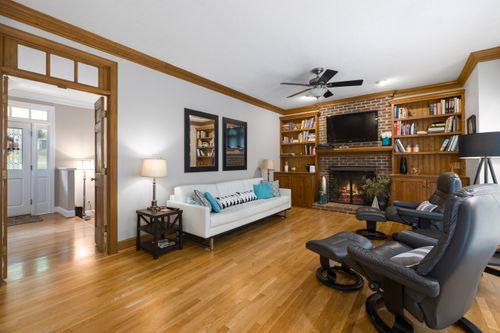 Free A warm and inviting living room with modern furniture, a fireplace, and built-in bookshelves. Stock Photo