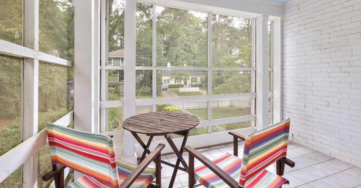 Inviting patio view with colorful chairs and table, perfect for relaxation.