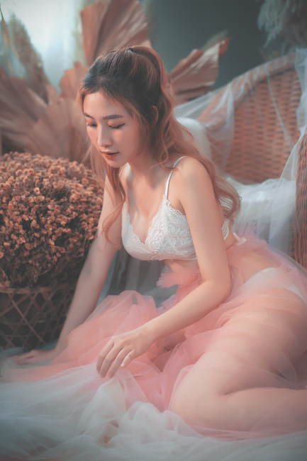 Embrace elegance in this modern indoor portrait featuring a young Asian woman in delicate attire.
