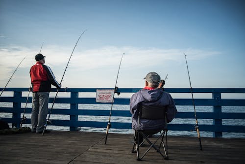 Men Fishing on the Wooden Dock