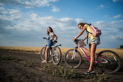 Women Riding a Bicycle while Looking at the Camera