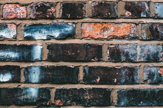 Close-up of a weathered brick wall showcasing diverse textures and colors.