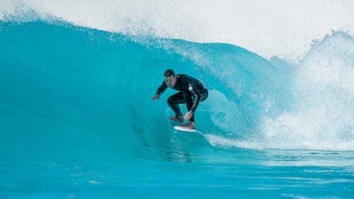 Free Man in Black Swimwear Surfing Stock Photo