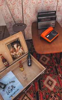 Explore a nostalgic retro room with vintage decor including a rotary phone, paintings, and assorted bottles.