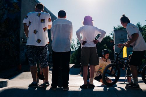 Free Teenagers enjoying BMX and skateboarding at an urban skate park. Stock Photo