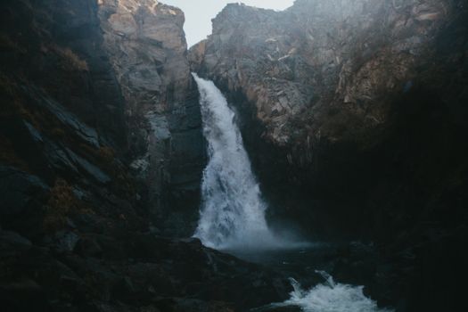 Water Falls Between Brown Rocky Mountain